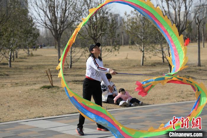 市民在公園里上演彩綢舞?！∴囆?攝