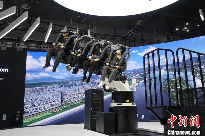 圖為觀眾在展會(huì)模擬體驗(yàn)未來(lái)城市空中移動(dòng)出行方式?！⑿?攝