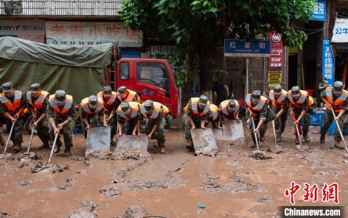 7月4日，萬州區(qū)五橋街道，武警官兵清理街道上的淤泥?！∪矫宪?攝