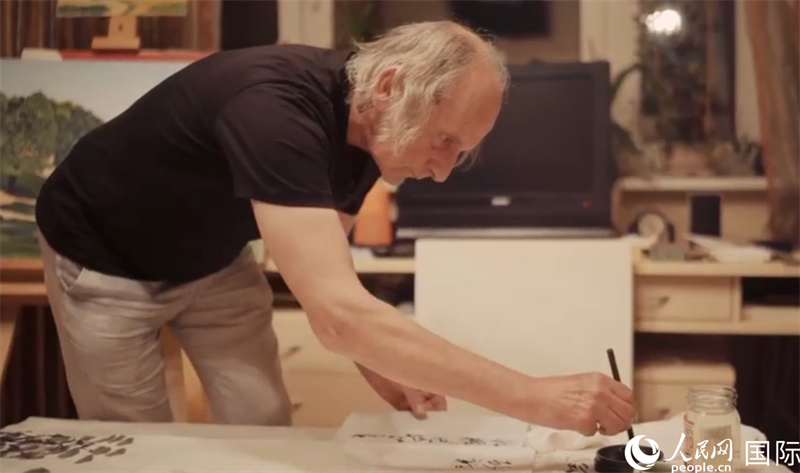 伊戈?duì)枴げ紶枛|諾夫在畫作上題詞。人民網(wǎng)記者 馬天翼攝