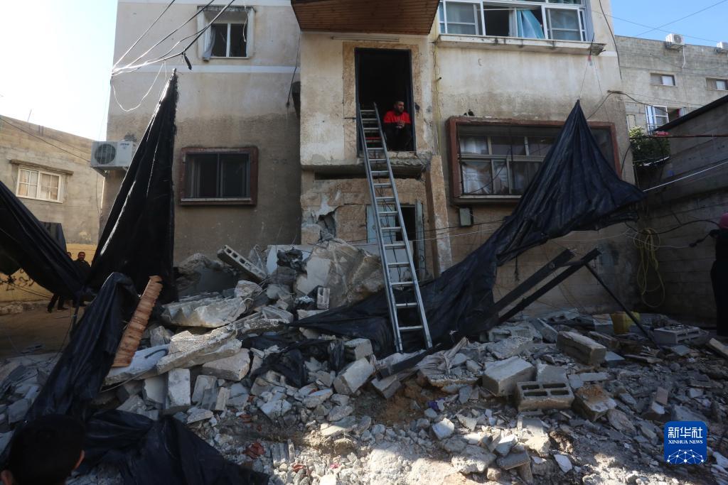 12月17日，在約旦河西岸城市圖勒凱爾姆附近的一處難民營，人們查看在沖突中損毀的房屋。新華社發(fā)（尼達(dá)爾·艾仕塔耶?dāng)z）