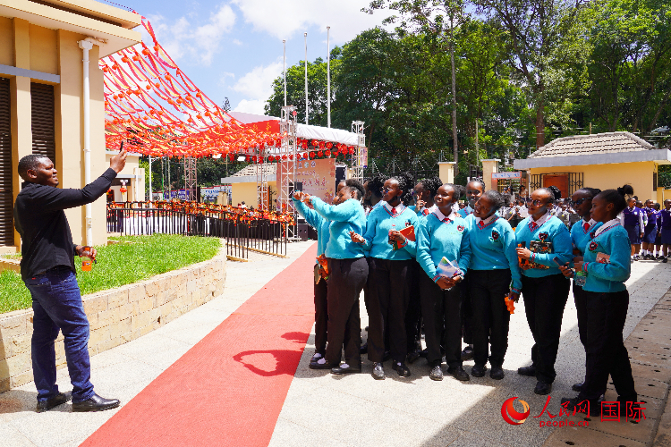 一名老師在給學生拍照留念。人民網(wǎng)記者 黃煒鑫攝