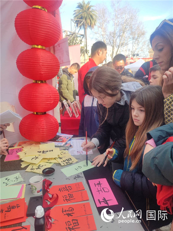 羅馬當(dāng)?shù)孛癖妼?duì)漢字充滿興趣。人民網(wǎng)記者鄭彬攝