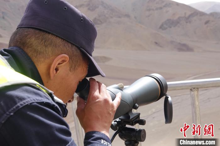 索朗曲扎用望遠(yuǎn)鏡查看邊境情況。　冉文娟 攝