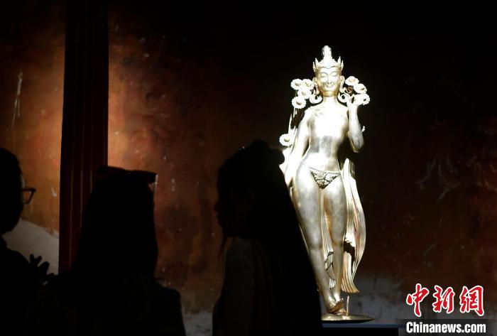 圖為觀眾正在欣賞展覽中的雕塑作品《八萬四千年》?！±盍?攝