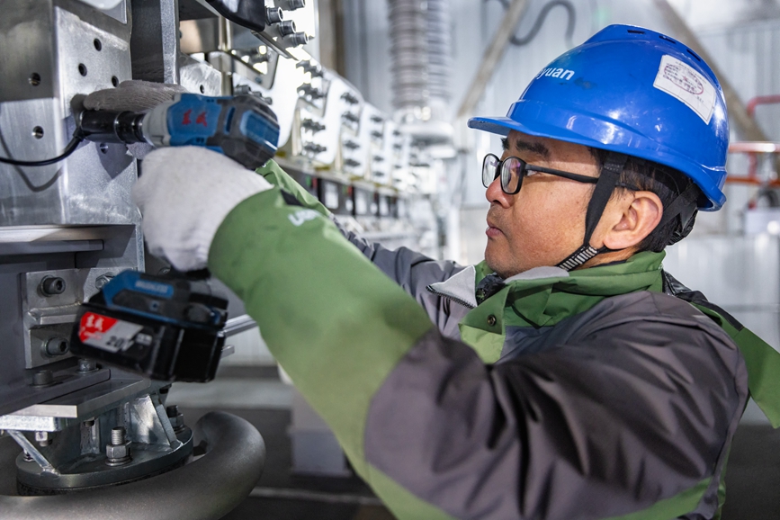 阿里地區(qū)首套電網(wǎng)側(cè)帶超容構(gòu)網(wǎng)型SVG工程現(xiàn)場(chǎng)工作人員正在進(jìn)行投運(yùn)前螺栓緊固工作。趙清鵬攝